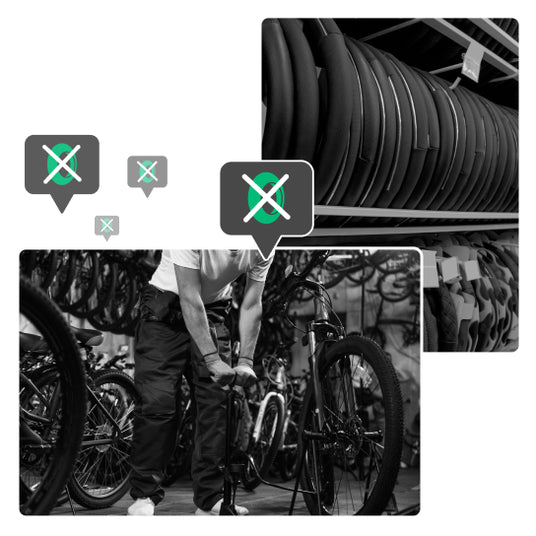 Fahrradmechaniker, der ein Fahrradrad aufpumpt und gelagerte Reifen